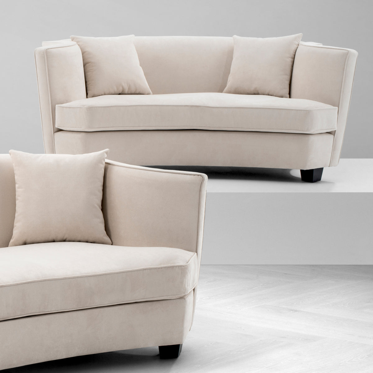 Modern loveseat with creamy velvet upholstery and sleek black wooden legs, designed for comfort in any living space.