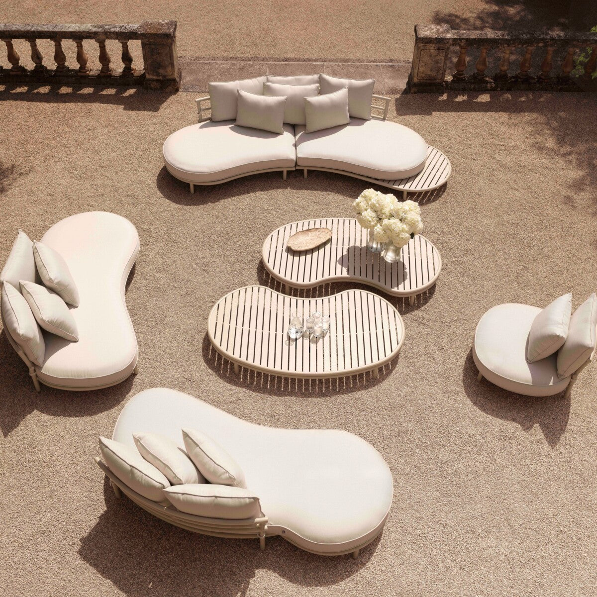 Laguno Sol oval outdoor garden sofa set in beige, featuring curved seating and wooden coffee tables, perfect for patios.