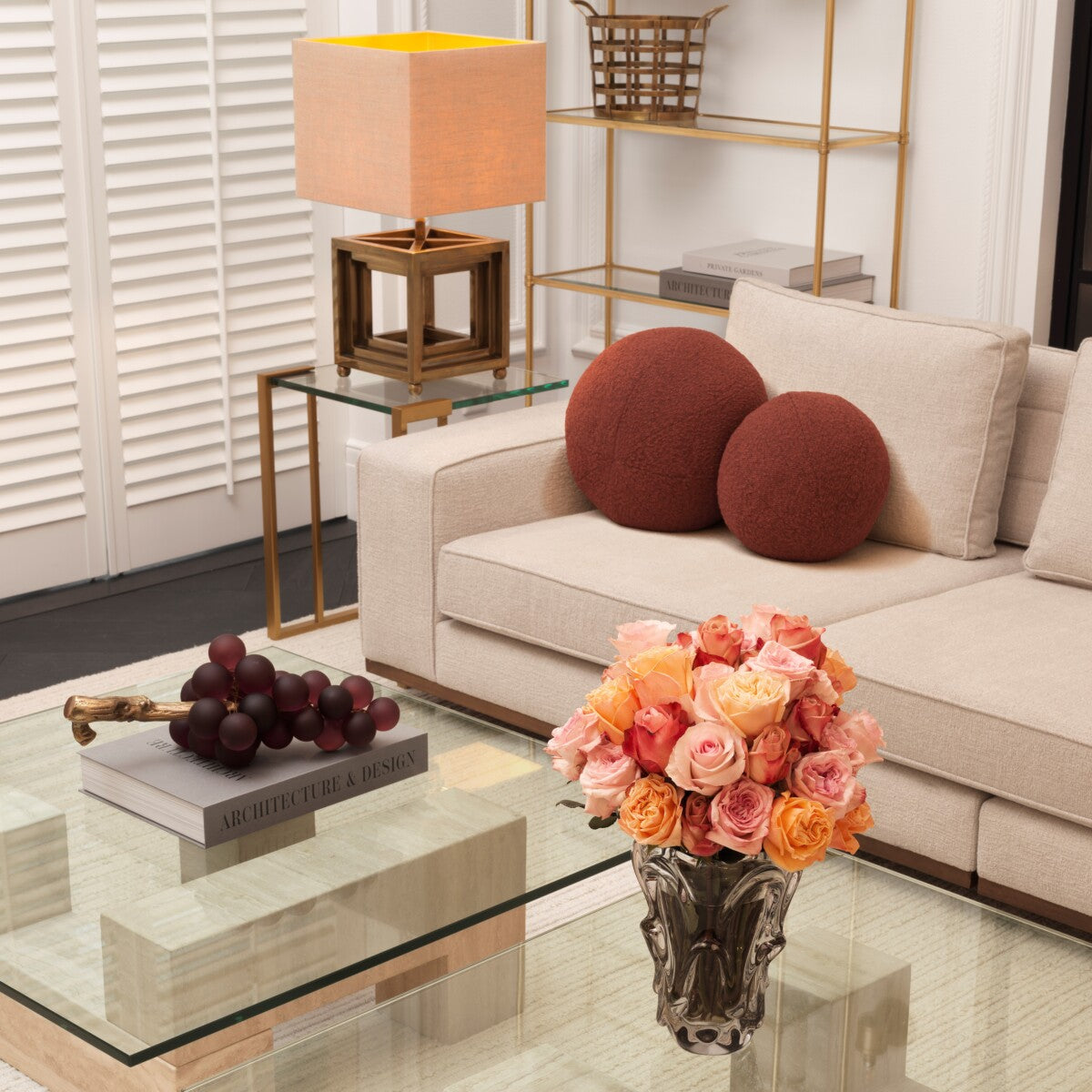 Stylish living room featuring an Aurora beige sofa, decorative pillows, flowers, and modern decor.