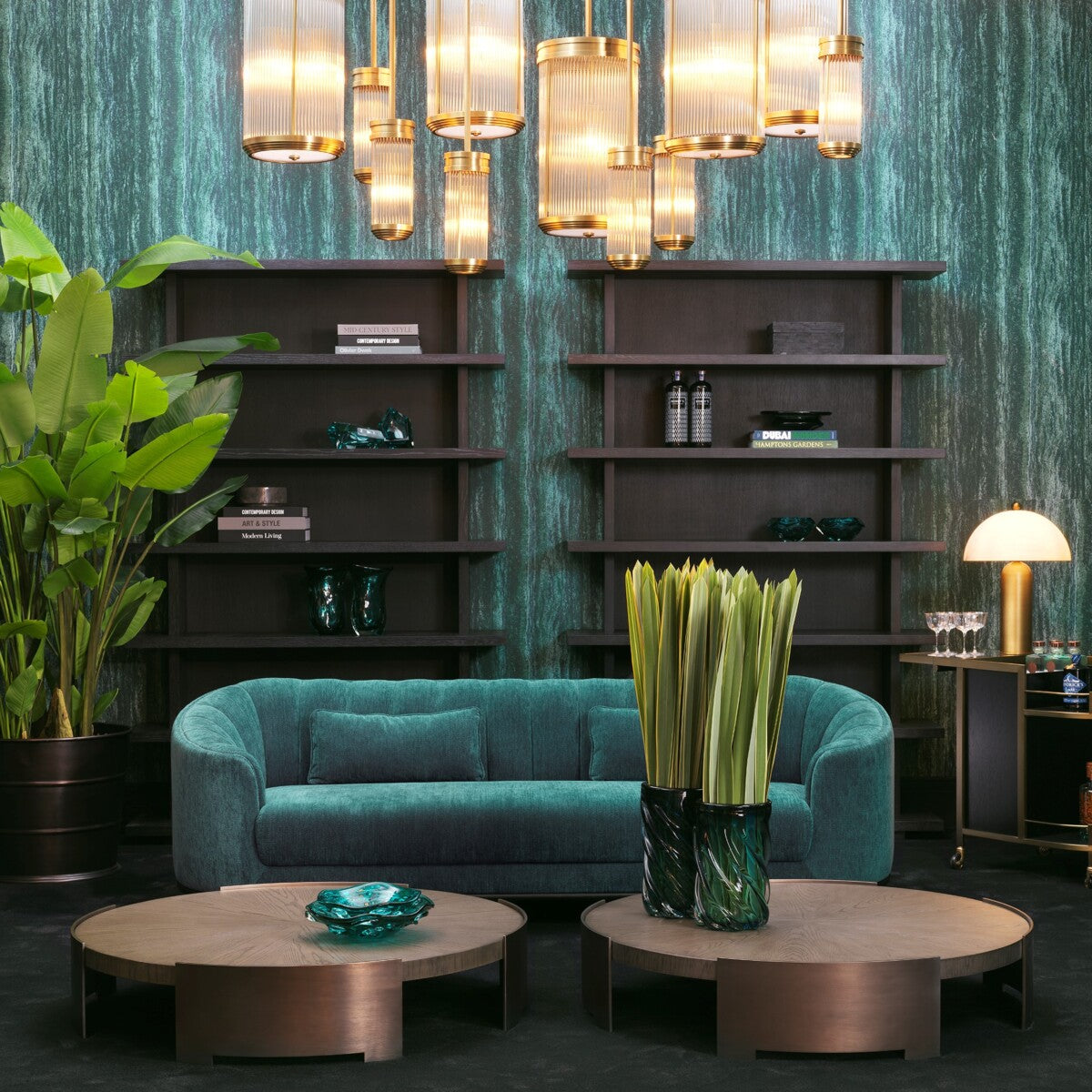 Modern teal sofa with circular coffee tables, surrounded by plants and stylish lighting fixtures.