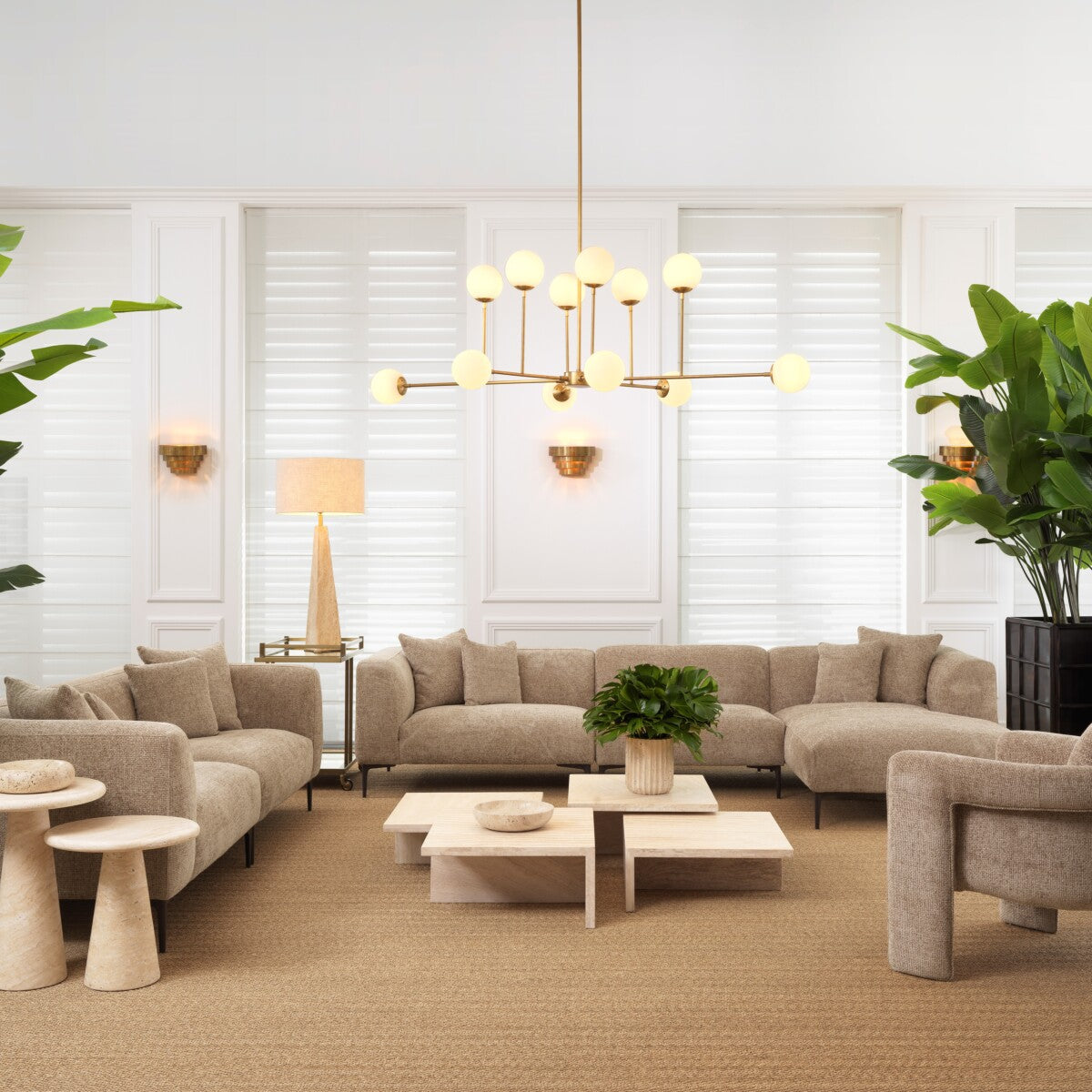 Modern living room featuring a beige sectional sofa, minimalist decor, and elegant lighting.