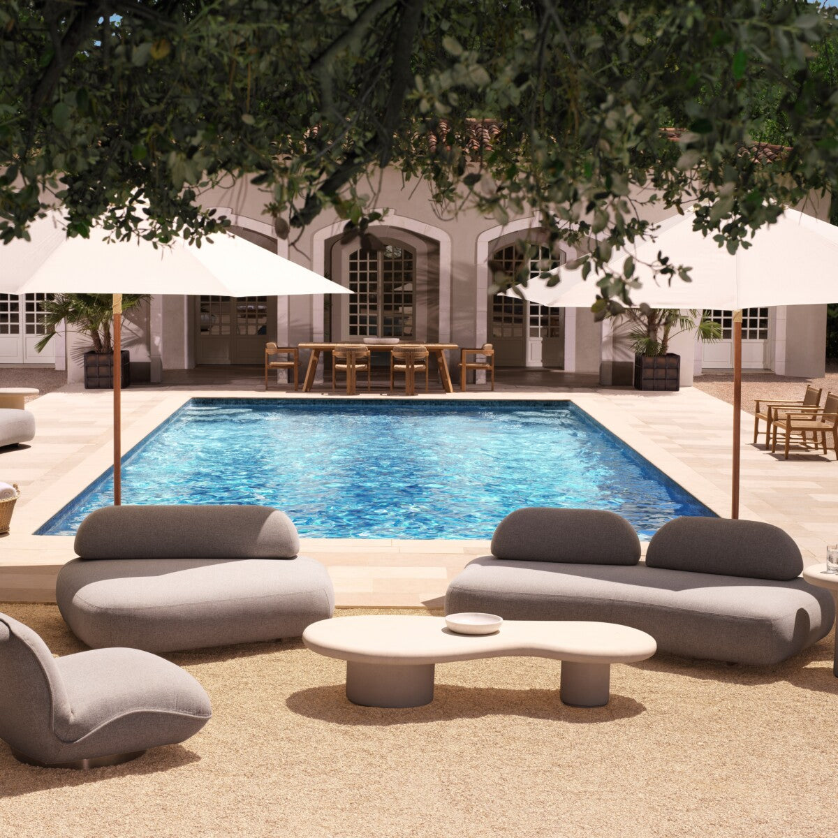 Modern outdoor garden furniture set around a pool with umbrellas, featuring oval-shaped couches and a round table.