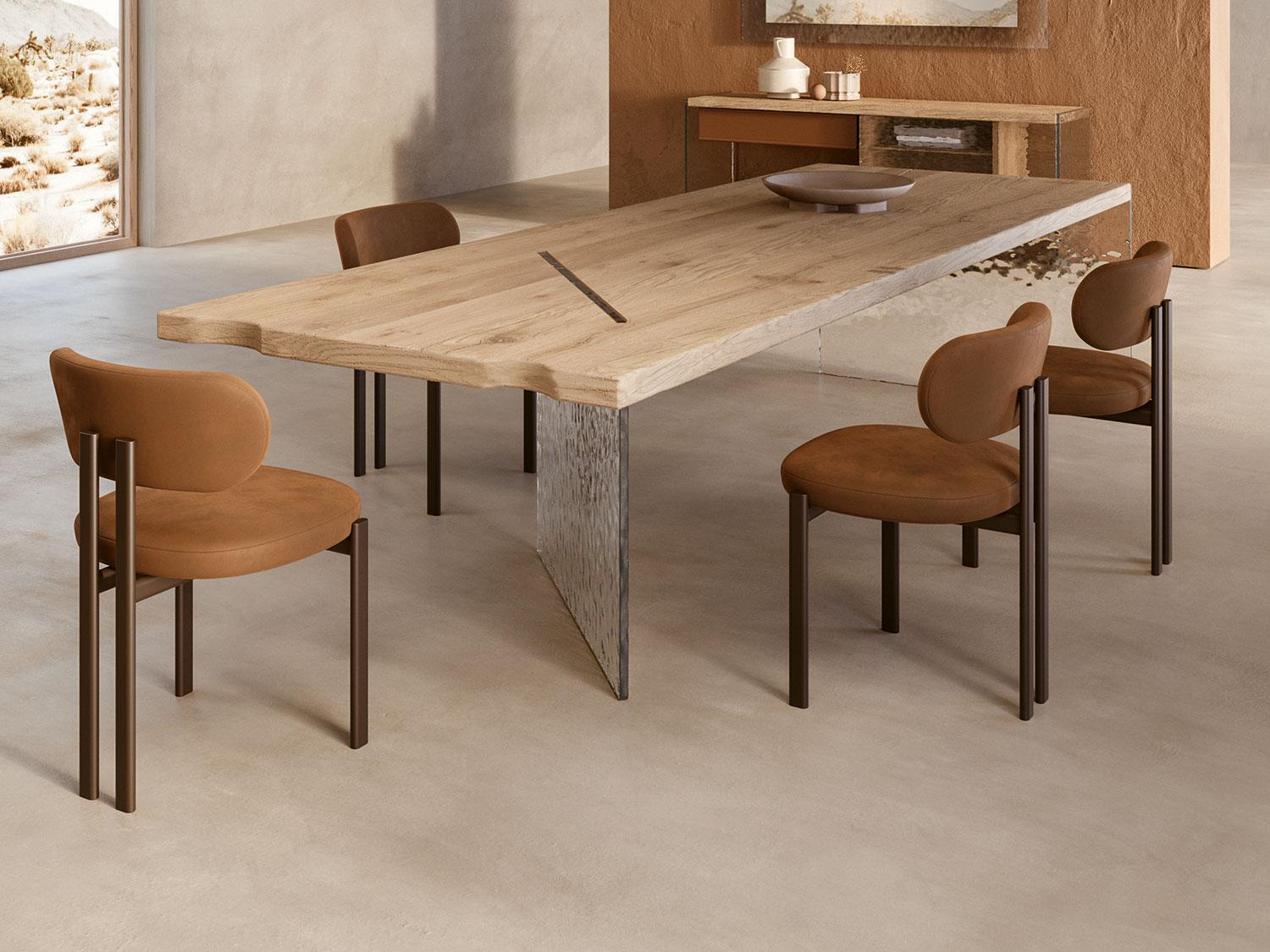 Modern dining room featuring a wooden table and Maile Taba Rengi suede chairs in walnut finish.
