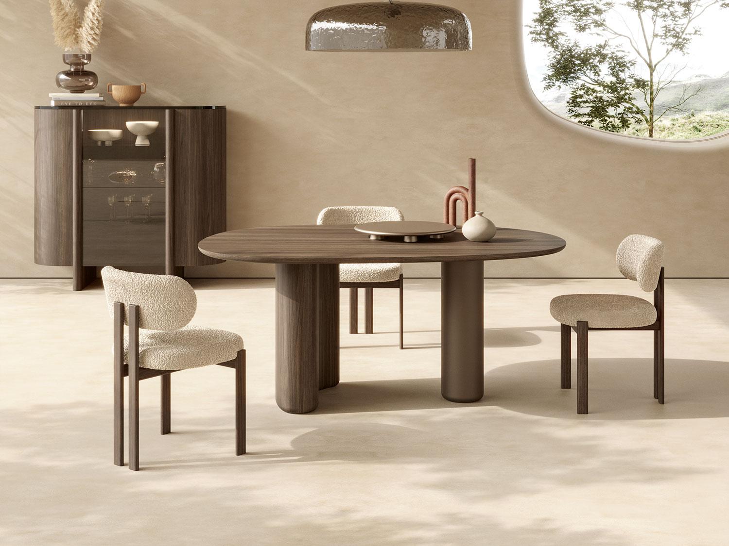 Modern dining room featuring Maile white teddy fabric wooden walnut lake chairs around a stylish round table.