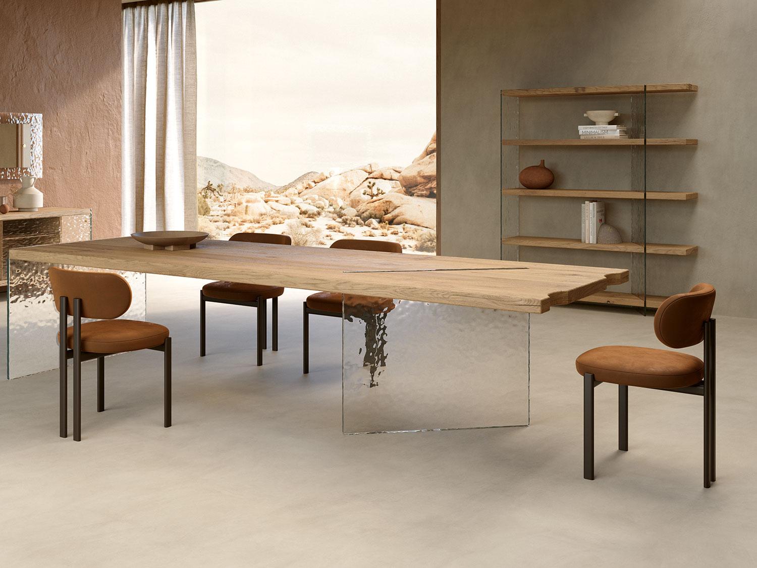 Modern dining room featuring a wooden table with sleek design and upholstered brown suede chairs, creating a stylish atmosphere.