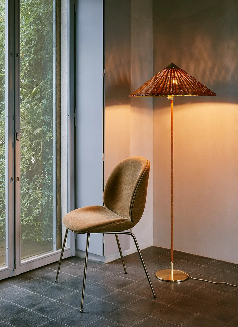 Metal legged chair with velvet fabric, next to a unique floor lamp in a stylish interior setting.