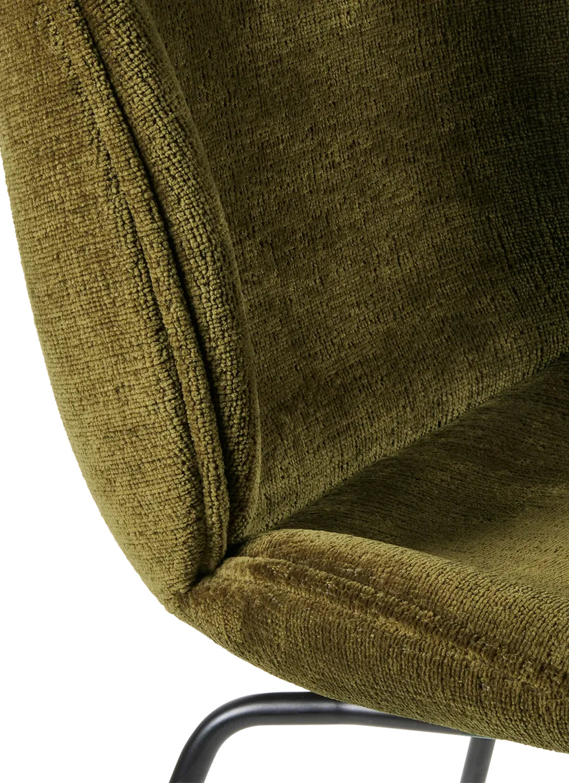 Close-up of Beetle Haki green chenille fabric chair with metal legs, showcasing the texture and design.