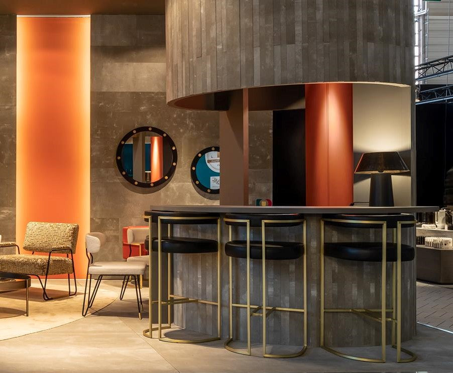 Modern interior featuring Julius Gri gold metal bar stools, stylish bar counter, and decorative elements.