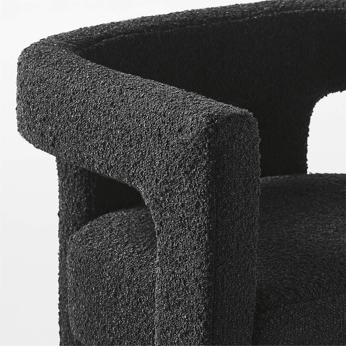Close-up of Syrah Siyah Teddy Bukle full fabric armchair showcasing textured black upholstery.